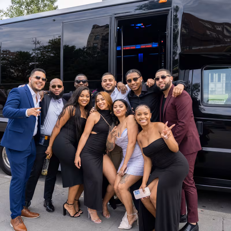 Group boarding a white charter bus for Birthday Transportation transportation in Orlando
