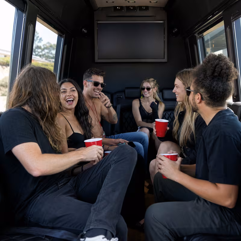Group boarding a white charter bus for Concert Transportation transportation in Orlando
