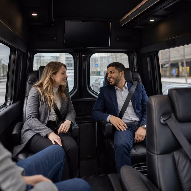 Group boarding a white charter bus for Corporate Transportation transportation in Orlando