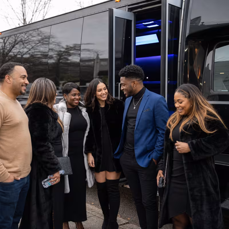 Passengers loading luggage while boarding an Orlando group shuttle