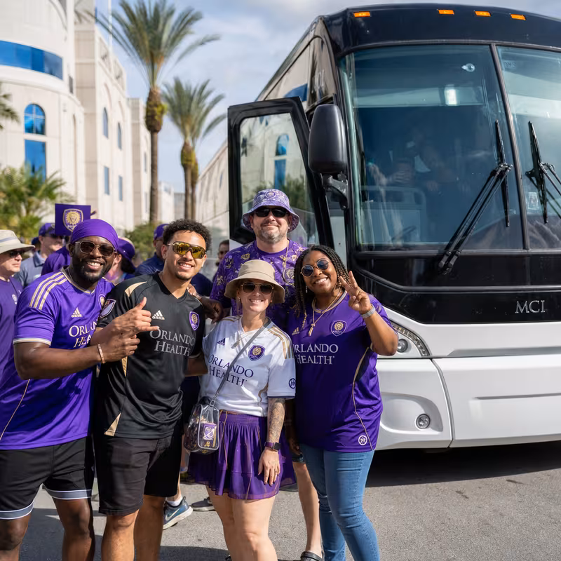 Passengers loading luggage while boarding an Orlando group shuttle