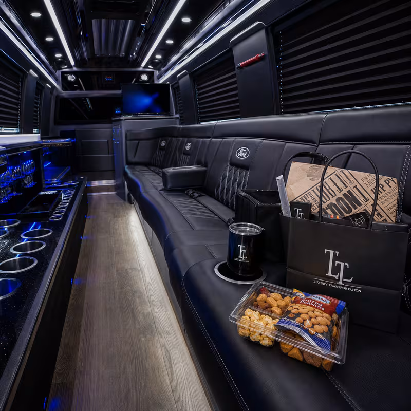 Party bus interior with wraparound leather seating and LED lighting in Orlando